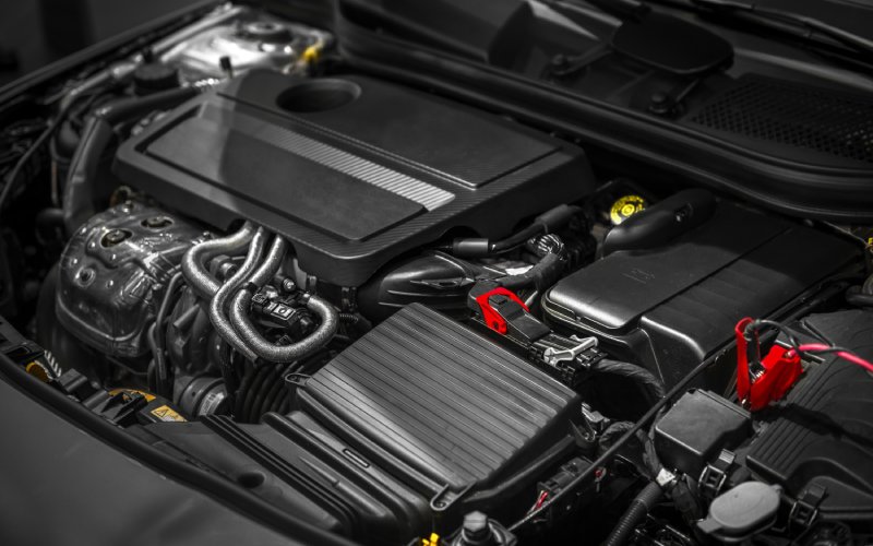 A close-up of a car engine. The engine appears to be clean and has no visible damage.